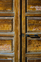 Old textured wooden door. Entrance to the house front view