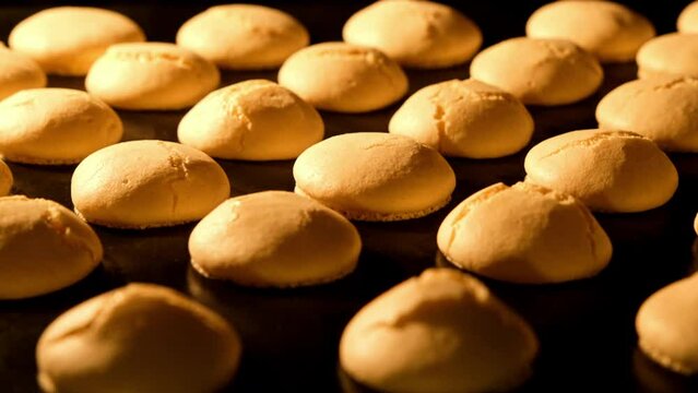 Baking macaroons in electric oven. Failed process. Exploded macarons. Failure. Timelapse of growing macarons. Delicious dessert. Process of cooking macaroons. Close-up in 4K, UHD