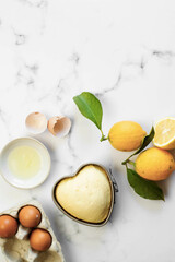 Heart lemon cake in preparation. White background and copy space