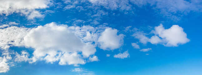 Naklejka na ściany i meble White clouds in the blue sky in sunny weather