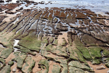 Coastline with the sea entering through geometrically shaped rocks