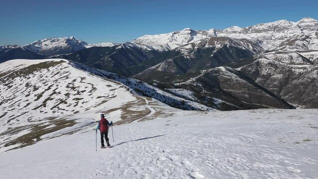 Mountaineer going down with snowshoes. Huesca Pyrenees