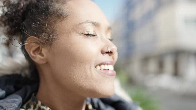 African american woman smiling confident breathing at street