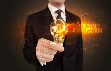 Businessman holding a lightbulb concept