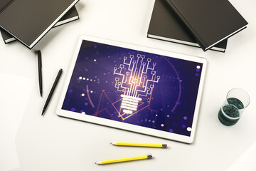 Creative light bulb with chip hologram on modern digital tablet screen, artificial Intelligence and neural networks concept. Top view. 3D Rendering