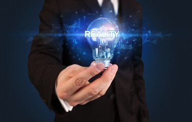 Businessman holding a light bulb