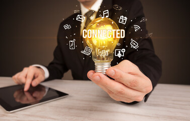 Businessman holding a light bulb, social media concept