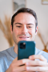 Young man with smartphone looking the news