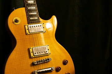 Yellow Amber Les Paul against a dark background