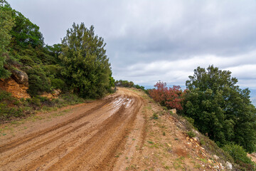 Fototapeta na wymiar Country road with mud at Penteli mountain at Attica, Greece.