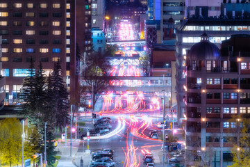 View of the night city. Street and transport. Blurred car lights. Traffic. Wallpaper and background. Skyscrapers and business centers.