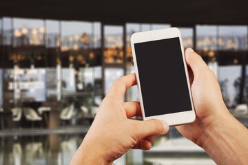 Hands hold a phone with a blank screen