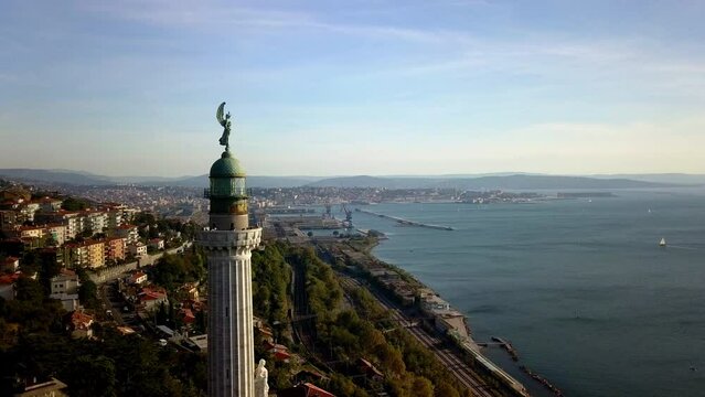 aerial drone shot of trieste gulf with vittoria lighthouse in foreground