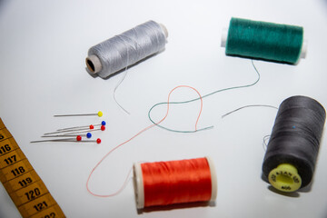 sewing thread forming a shape of heart with some other sewing equipment on the picture. sewing...