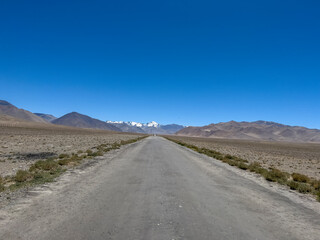 Fototapeta na wymiar A long way and behind Pamir mountains.