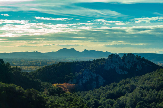 Beautiful Landscape in the Luberon massif (moutain), near the Gorges of Regalon. Evening light, sunset sky, stone cliff and trees. Cheval Blanc, France.