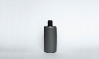 Grey blank plastic bottle for gel, liquid soap, lotion, cream, shampoo on white background. Cosmetics.