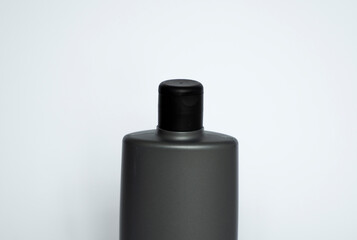 Close up grey blank plastic bottle for gel, liquid soap, lotion, cream, shampoo on white background. Cosmetics.
