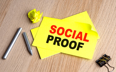 SOCIAL PROOF written on a sticky on notebooks