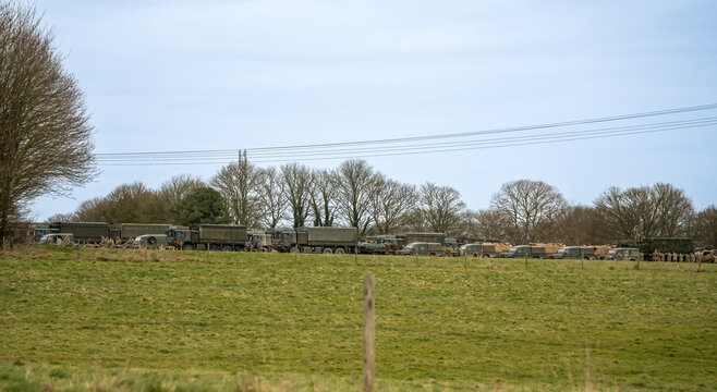 a camp of British army logistics vehicles, Defender Wolf and MAN SV 4x4 
