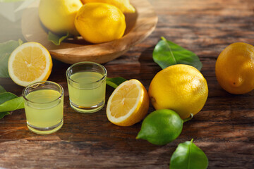 Limoncello, Italian liqueur with lemons. Traditional Mediterranean sweet shot alcoholic drink close...