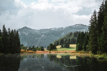 Fototapeta premium Lac de Morgins in winter with mountains covered in snow, Pas de Morgins