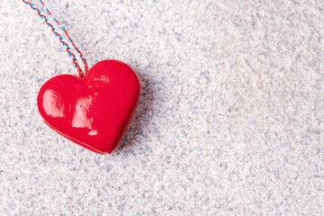 Red toy heart on granite stone textured background. Valentines day concept. Top view, flat lay, copy space