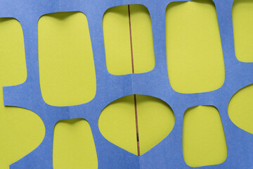 paper grid with large cutouts on green