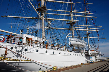 Old vintage sailboat moored in a port.
