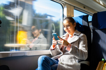 Portrait of Happy Asian woman enjoy city lifestyle travel Japan on train in autumn holiday...