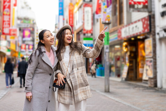 Asian Woman Friends Shopping Together At Shibuya District, Tokyo, Japan With Crowd Of People Walking In The City. Attractive Girl Enjoy And Fun Outdoor Lifestyle Travel City In Autumn Holiday Vacation