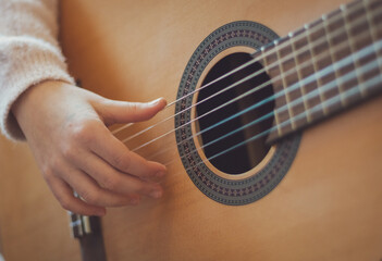 Fototapeta premium Little girl plays the guitar.