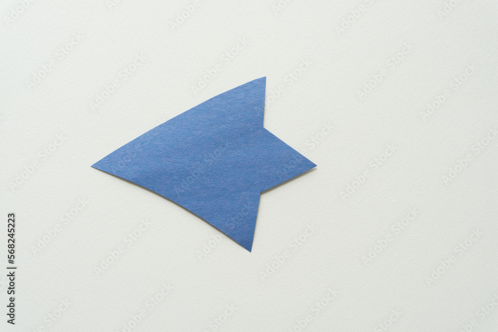 Wall mural blue paper arrow on blank paper