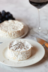 Camembert french soft cheese served with red wine and grapes