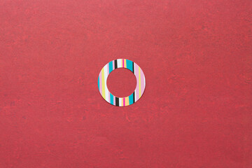 paper sticker ring with stripes on deep red scrapbook paper 