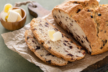 Soda bread in a cast iron pan with cranberries and pecans