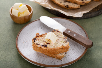 Soda bread in a cast iron pan with cranberries and pecans