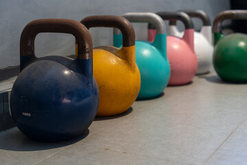 Naklejka na ściany i meble At home gym including kettlebell weights, person getting fit and strong