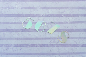 numbers 5, 6, 7, 8 cut from iridescent card stock and arranged on scrapbook paper with horizontal...