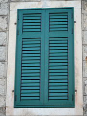 old window with shutters on the wall