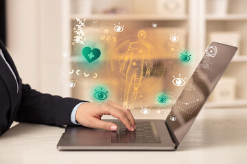 Doctor working on laptop with healthcare concept