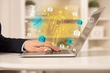 Doctor working on laptop with healthcare concept