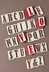 alphabet and wood heart ornaments under letters l, o, v, and e