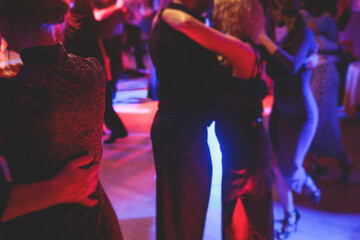 Couples dancing traditional latin argentinian dance milonga in the ballroom on a festival, tango...