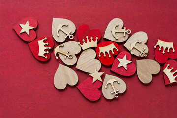 scattered collection of hearts, anchors, and stars on red paper