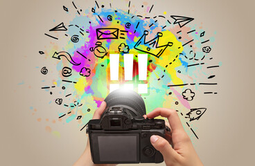 Close-up of a hand holding digital camera with abstract drawing concept