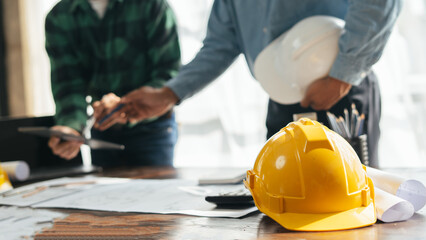Close up of hands working brainstorming and measuring for cost estimating on paperworks and floor plan drawings about design architectural and engineering for houses and buildings..