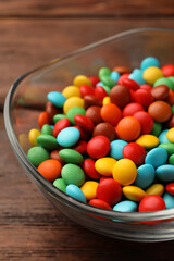 Tasty colorful candies on wooden table, closeup