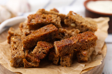 Delicious crispy rusks on table, closeup view