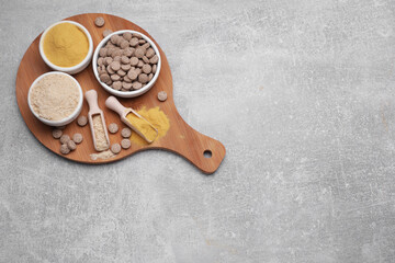 Different types of brewer's yeast on grey table, top view. Space for text